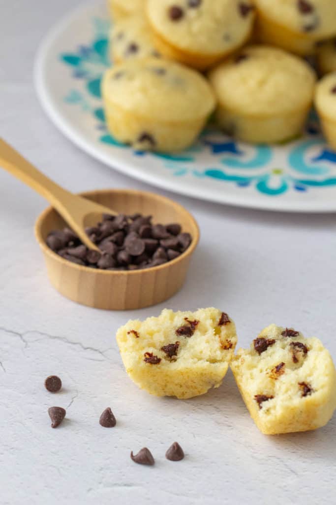 halved chocolate chip mini muffin with chocolate chips in a bowl