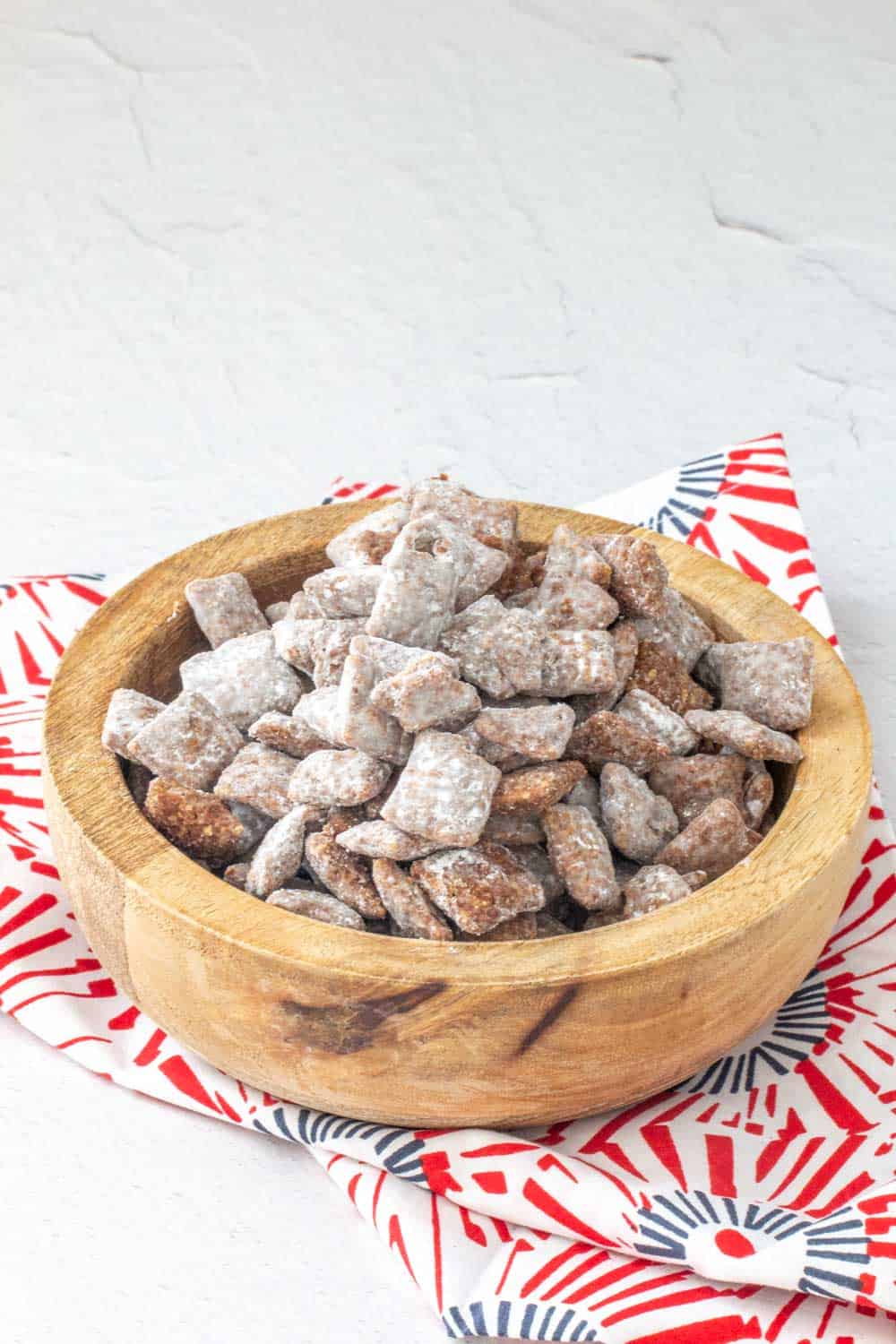 puppy chow snack mix in a wooden bowl