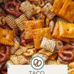 Close-up of a snack mix featuring taco Chex Mix with cheese crackers, pretzels, and taco seasoning. Text at the bottom reads "Taco Chex Mix happysnackcidents.com.