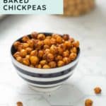 A bowl of perfectly crispy baked chickpeas sits on a white surface, with a few scattered around—an easy recipe for snack lovers. Text reads "Easy Recipe: Crispy Baked Chickpeas." Visit happysnackcidents.com.