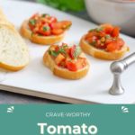 Slices of baguette topped with diced tomatoes and herbs are artfully arranged on a platter for a crave-worthy presentation. A bowl brimming with extra tomato bruschetta filling sits in the background, ensuring you'll never run out of this irresistible appetizer.