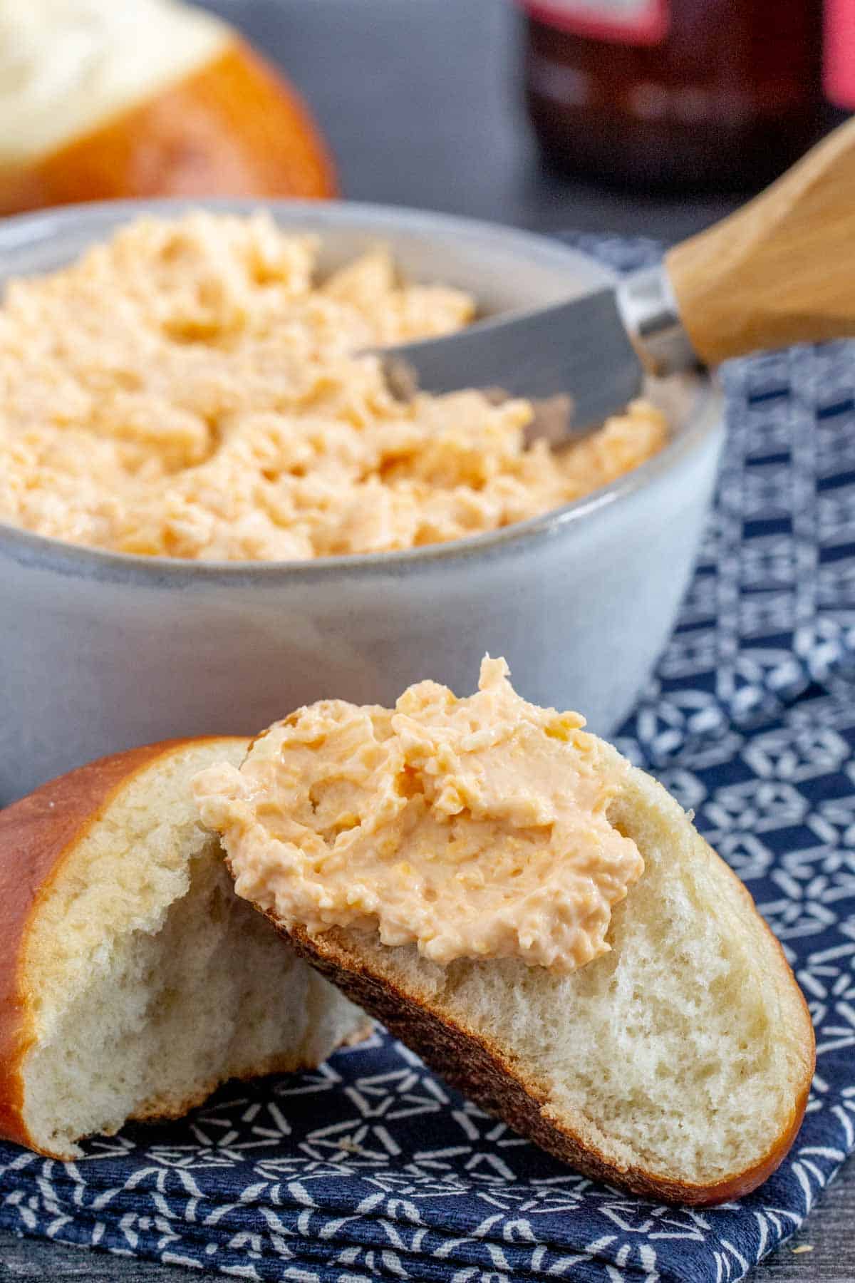 beer cheese dip on soft pretzel roll