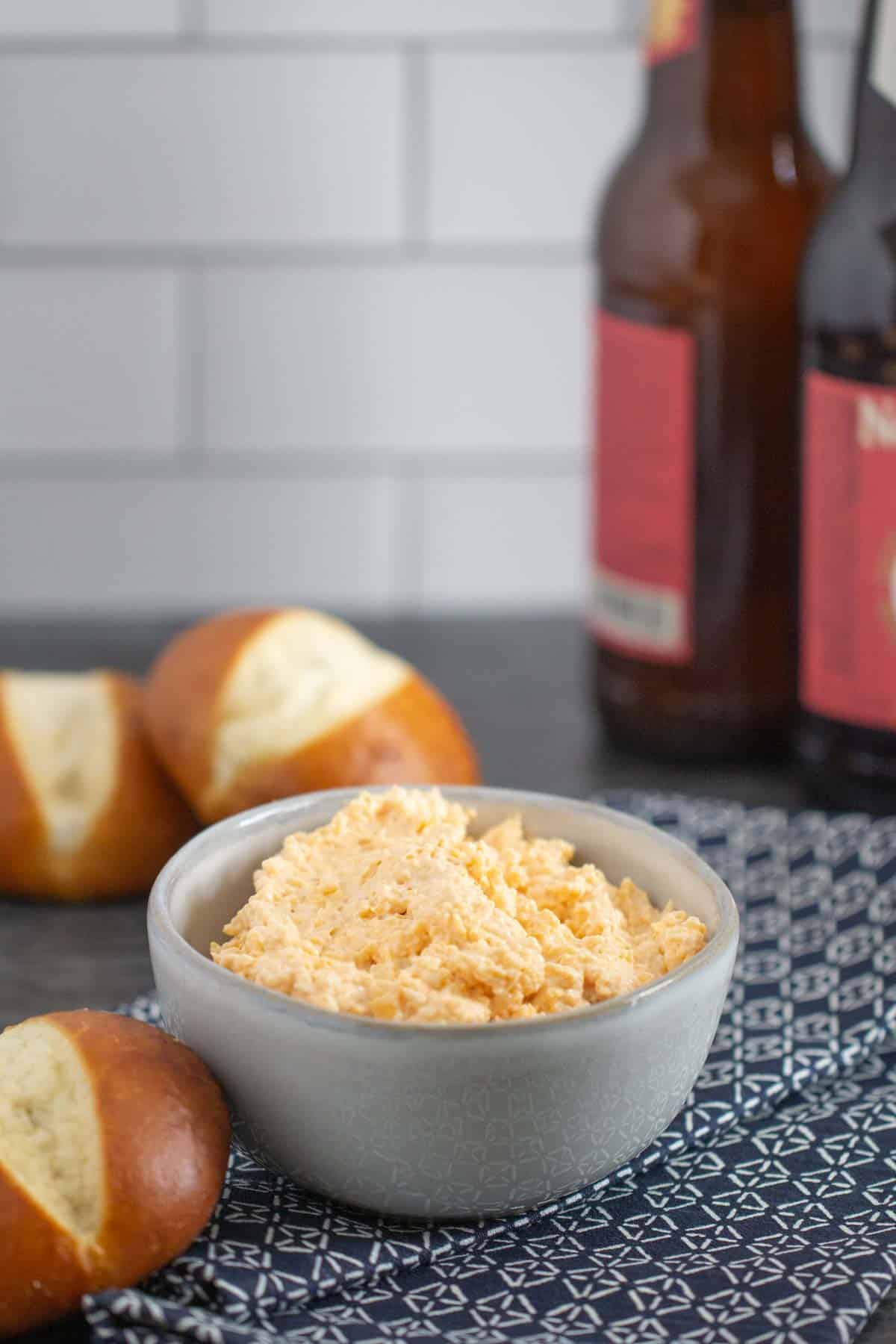 bowl of beer cheese dip with pretzel rolls