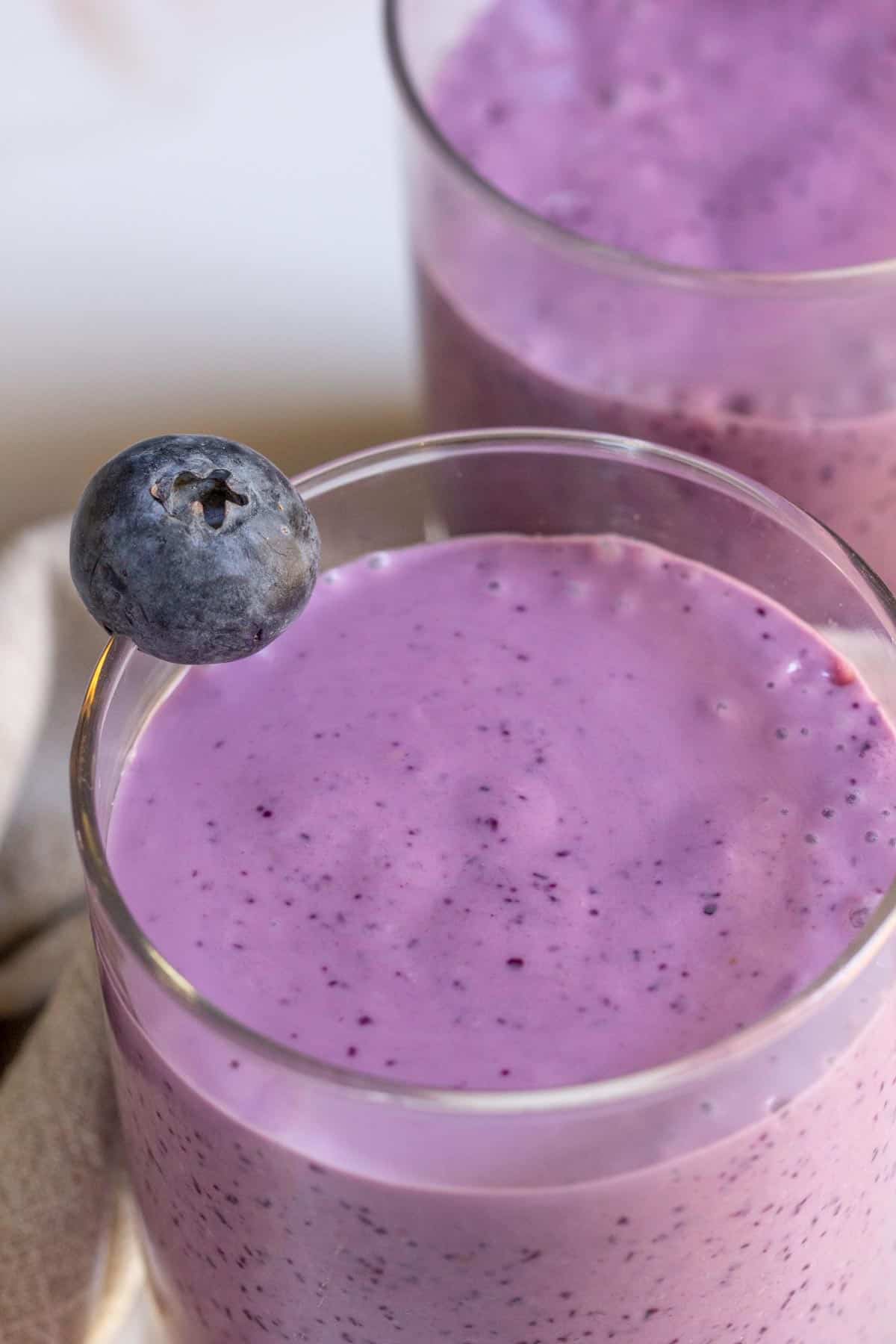 overhead of blueberry smoothie in a glass