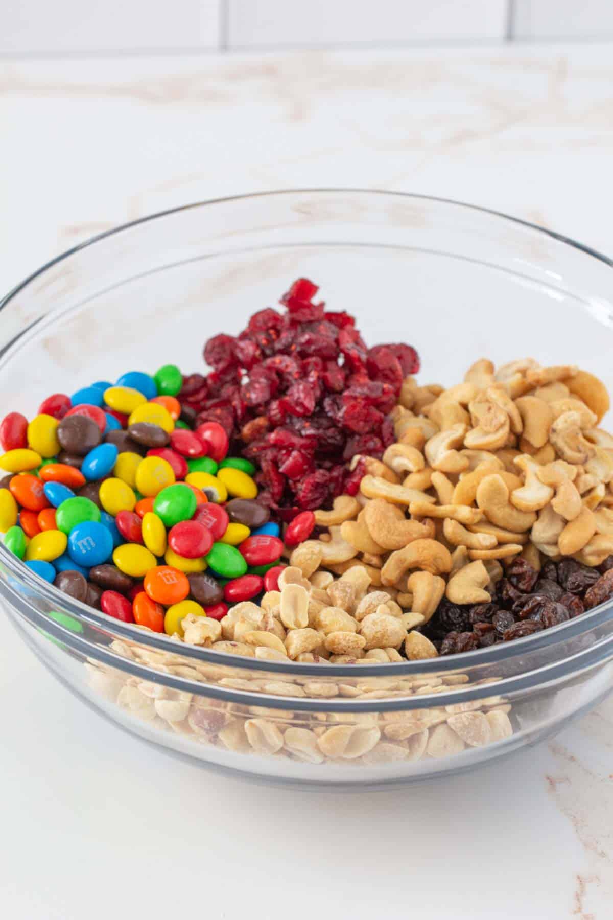 mixing bowl filled with trail mix ingredients