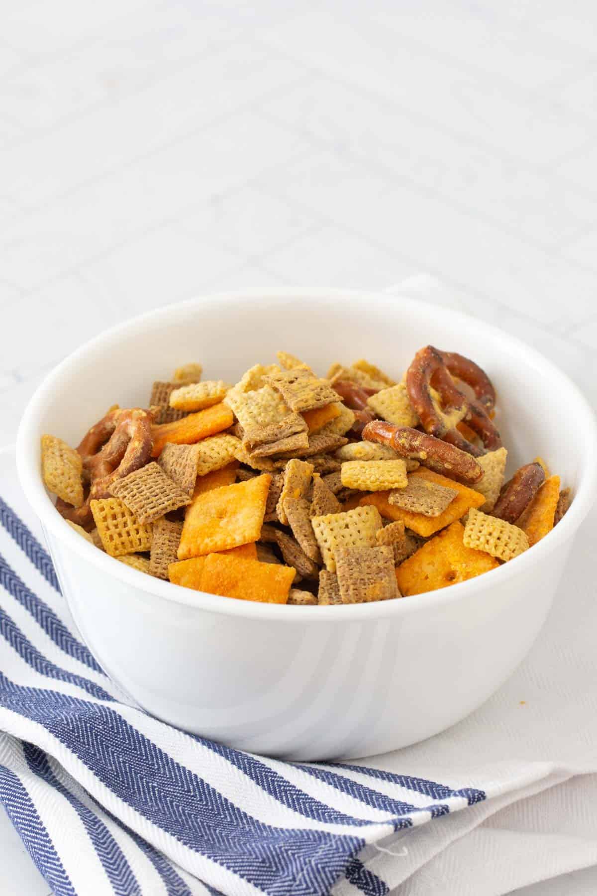 homemade cheddar chex mix in white bowl