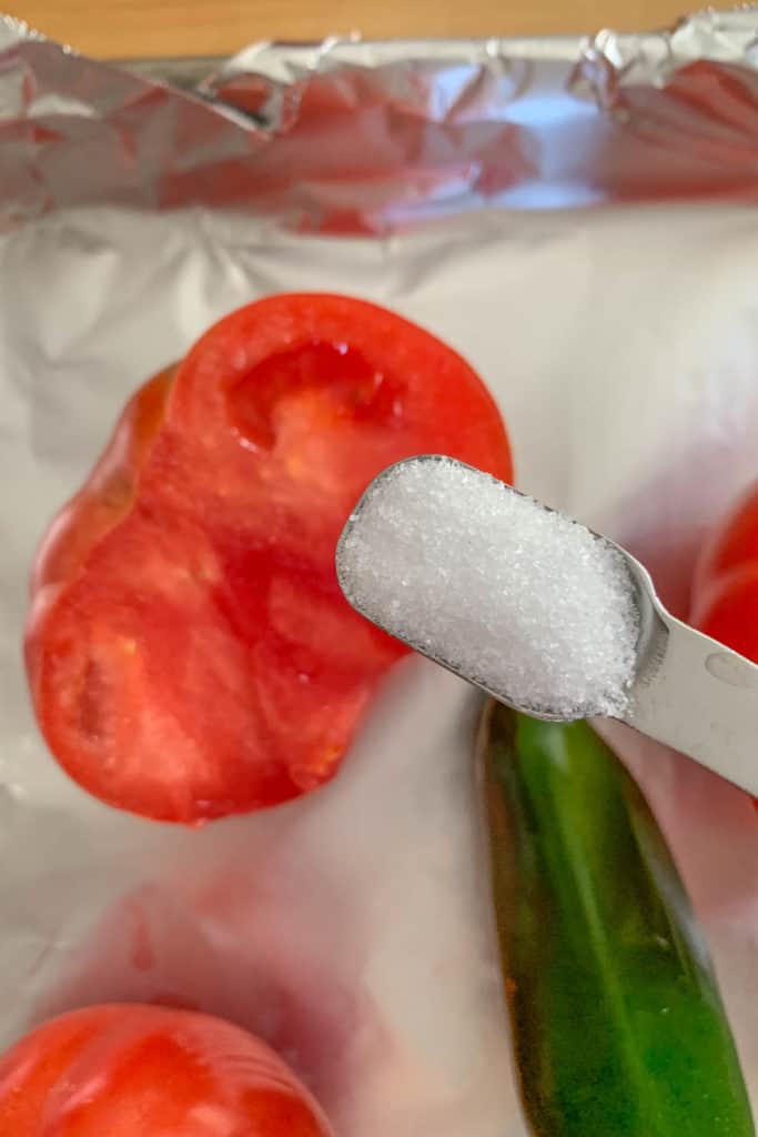 putting salt on tomatoes