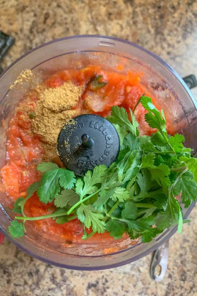 adding cilantro to salsa