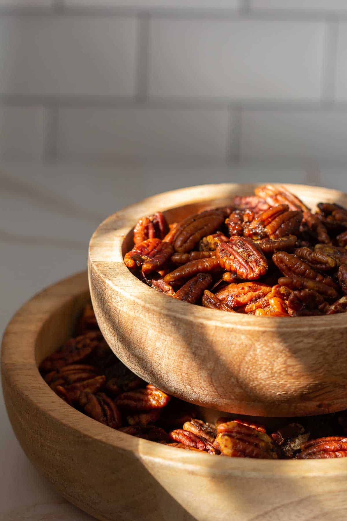 spiced pecans in a stacked nut bowl