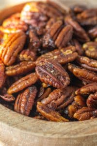 spiced pecans in a wooden bowl