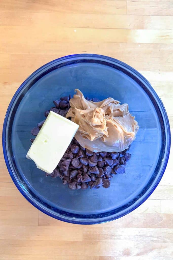 Peanut butter, butter, and chocolate chips in a bowl.