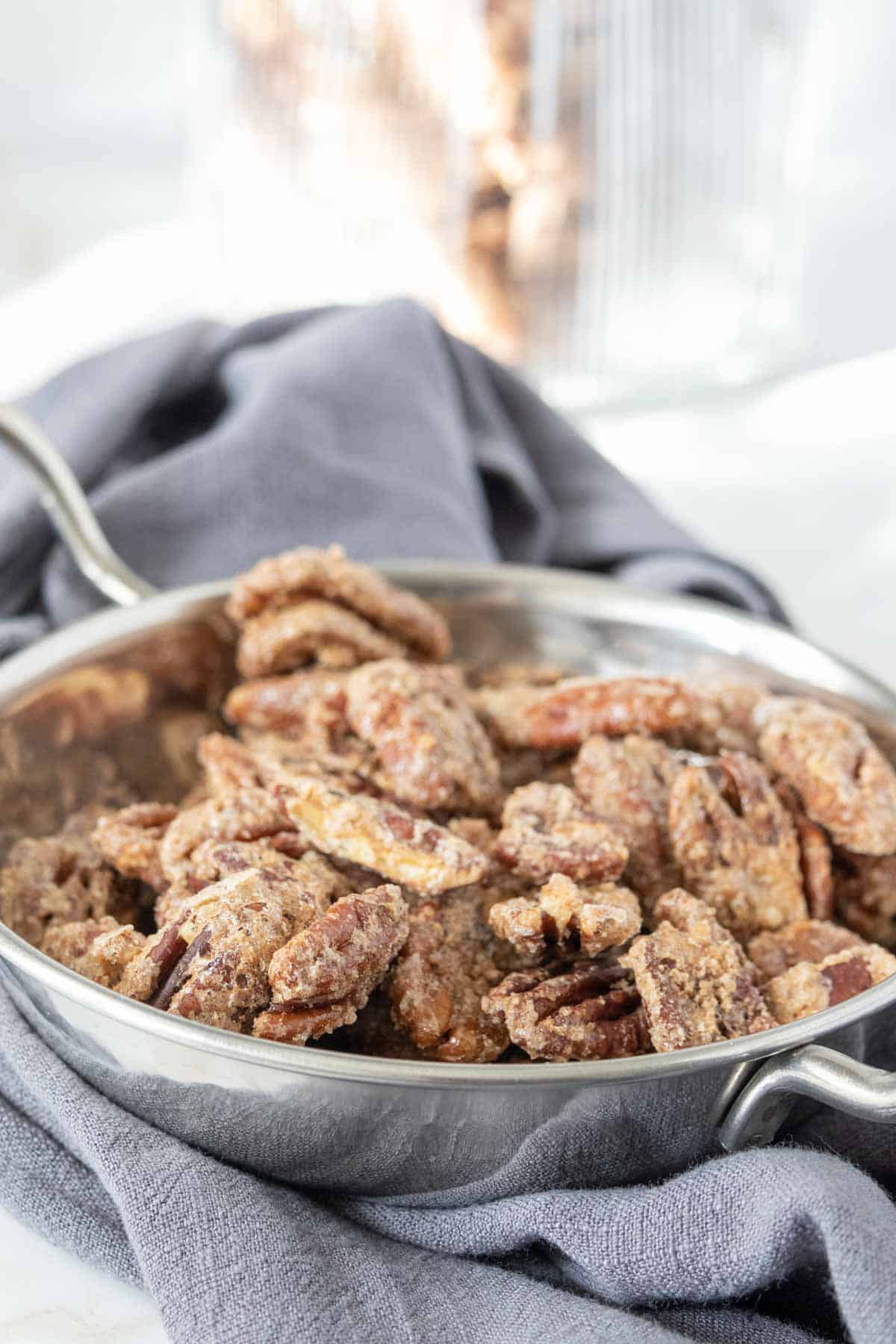 Silver bowl of candied pecans.