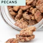 A jar tipped on its side spills candied pecans onto a white surface. The label reads, "SWEET & NUTTY CANDIED PECANS," showcasing these irresistible treats.