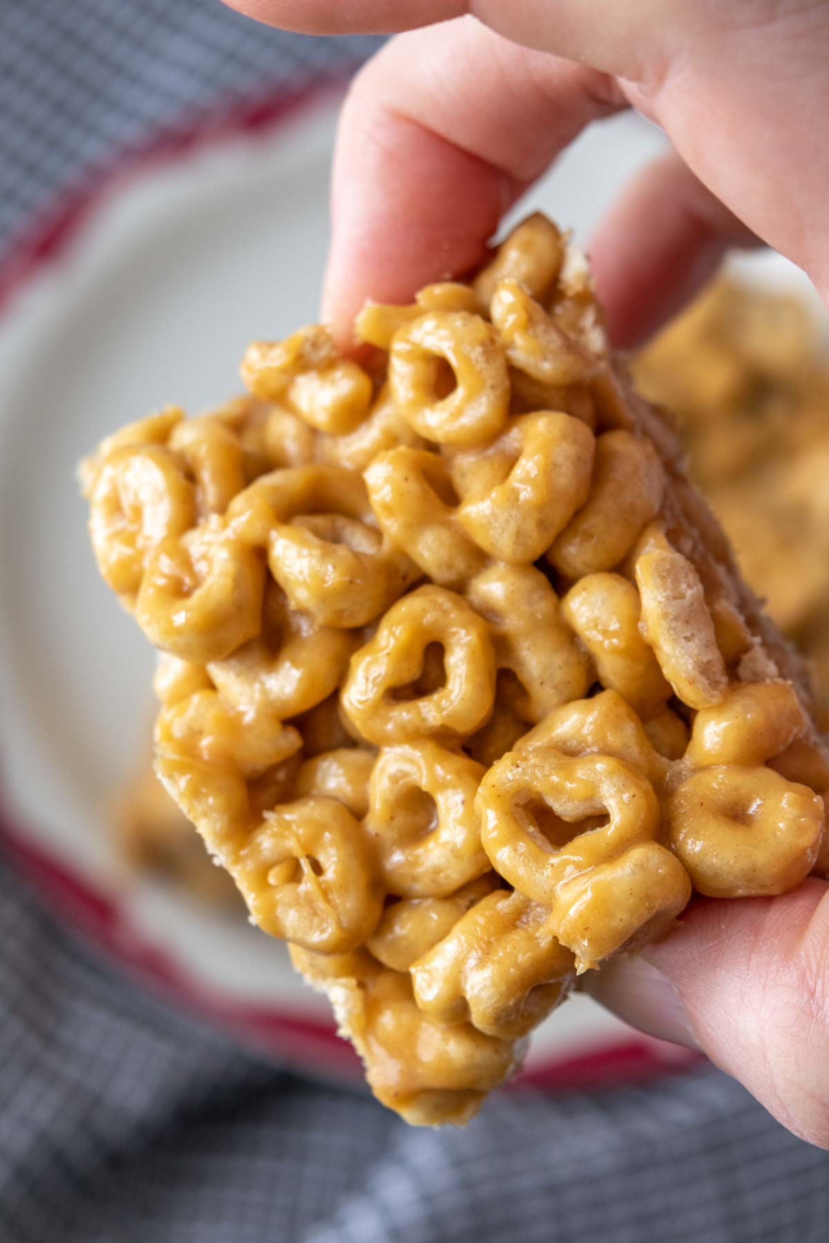 Caucasian hand holding sliced cereal bar.