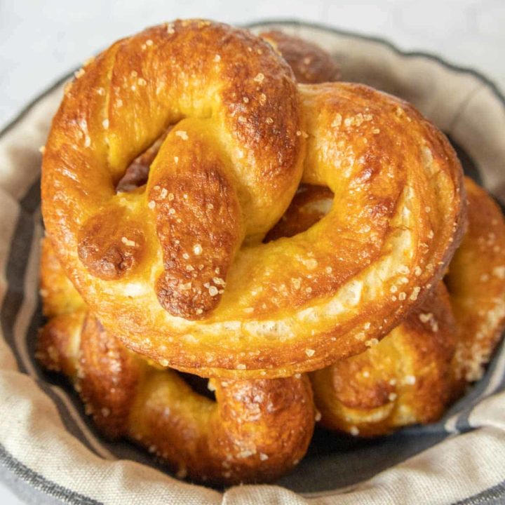 Stack of homemade soft pretzels in a bowl.