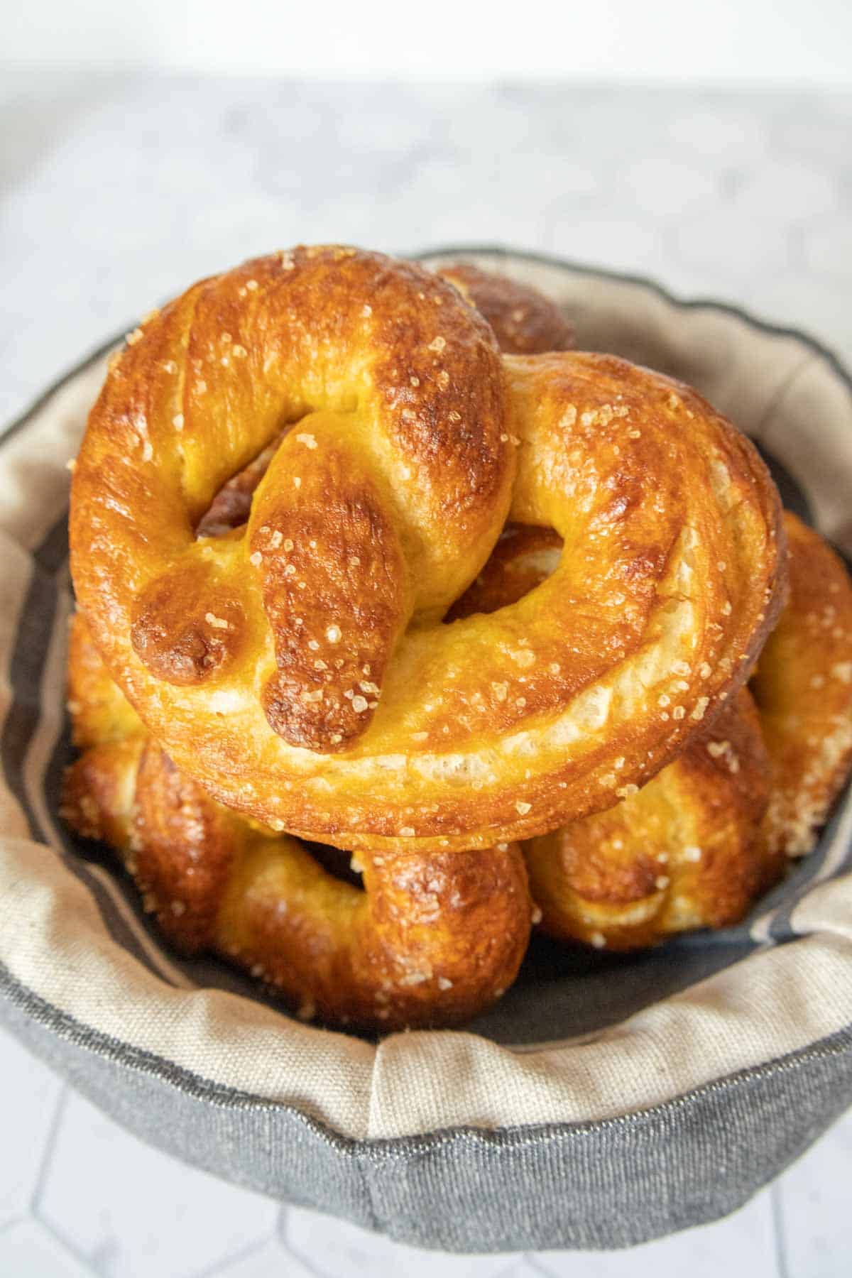 Stack of homemade soft pretzels in a bowl.