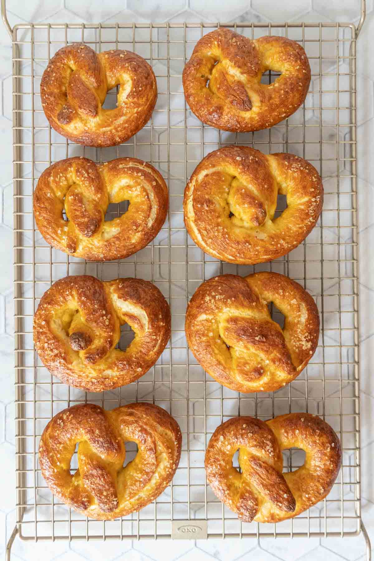 Homemade soft pretzels on a cooling rack.