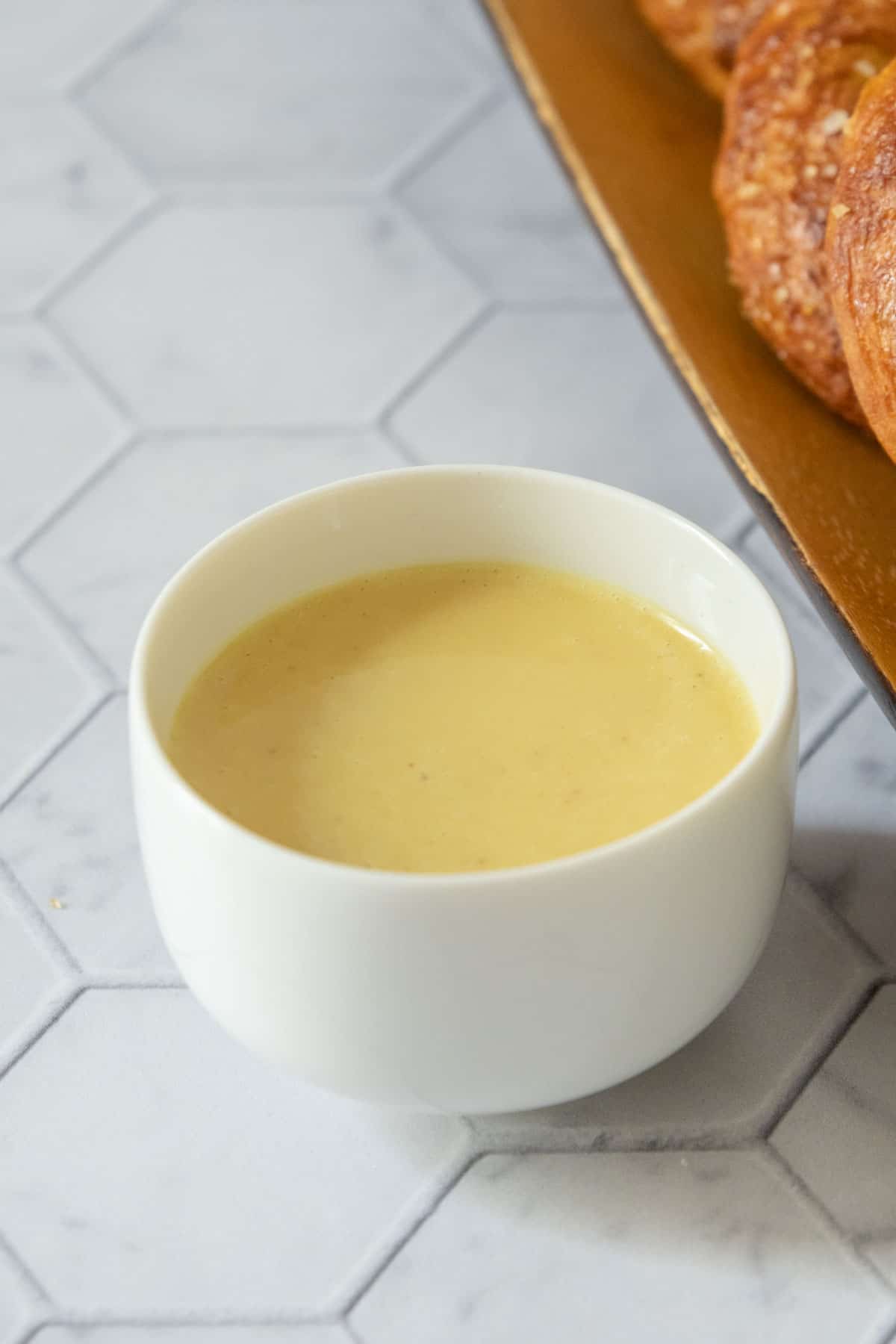 Small white bowl filled with honey mustard sauce.