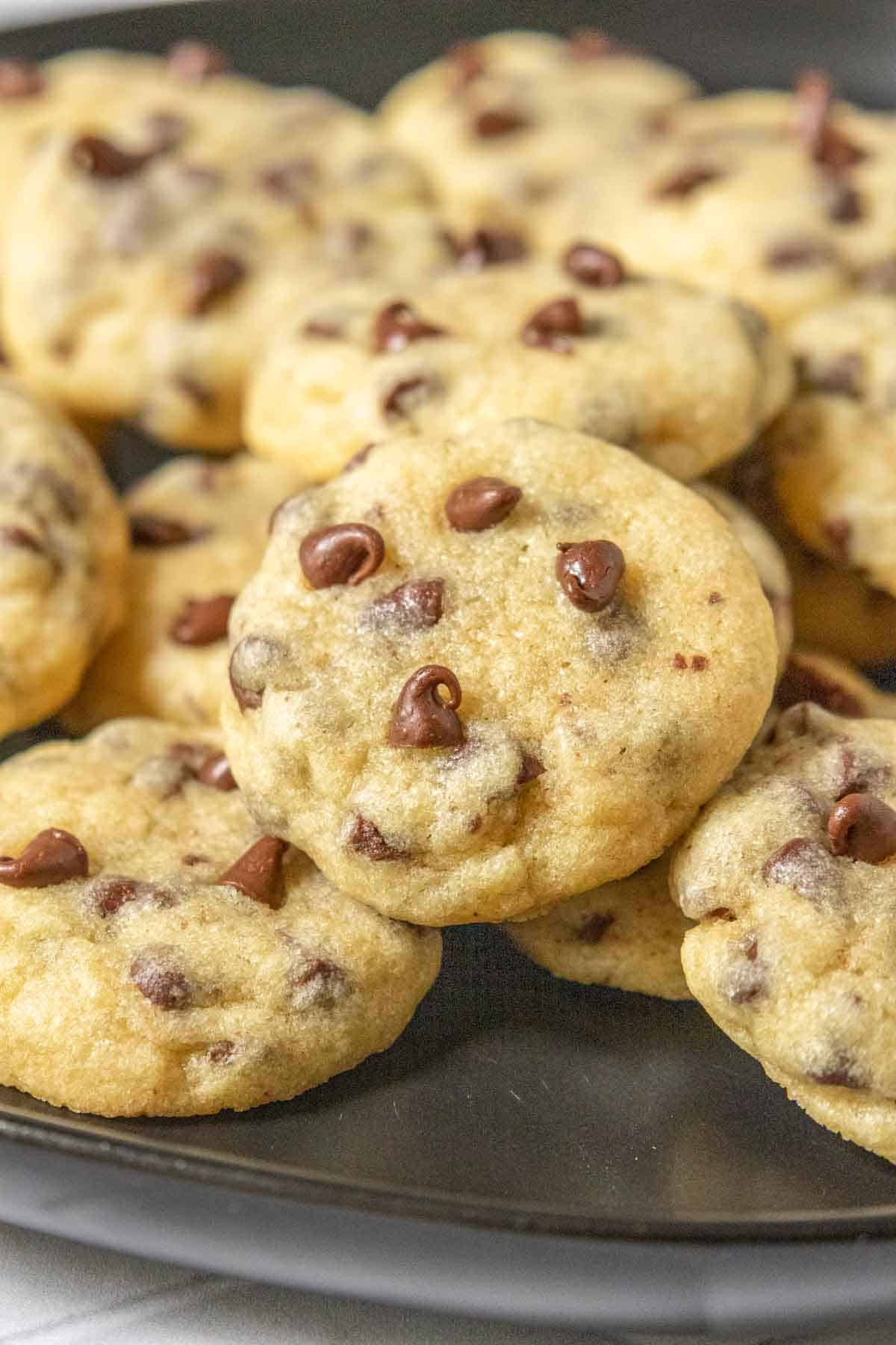 Plate of mini chocolate chip cookies close up.