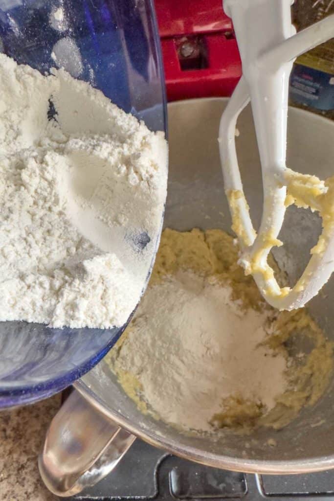 Adding flour to cookie dough.