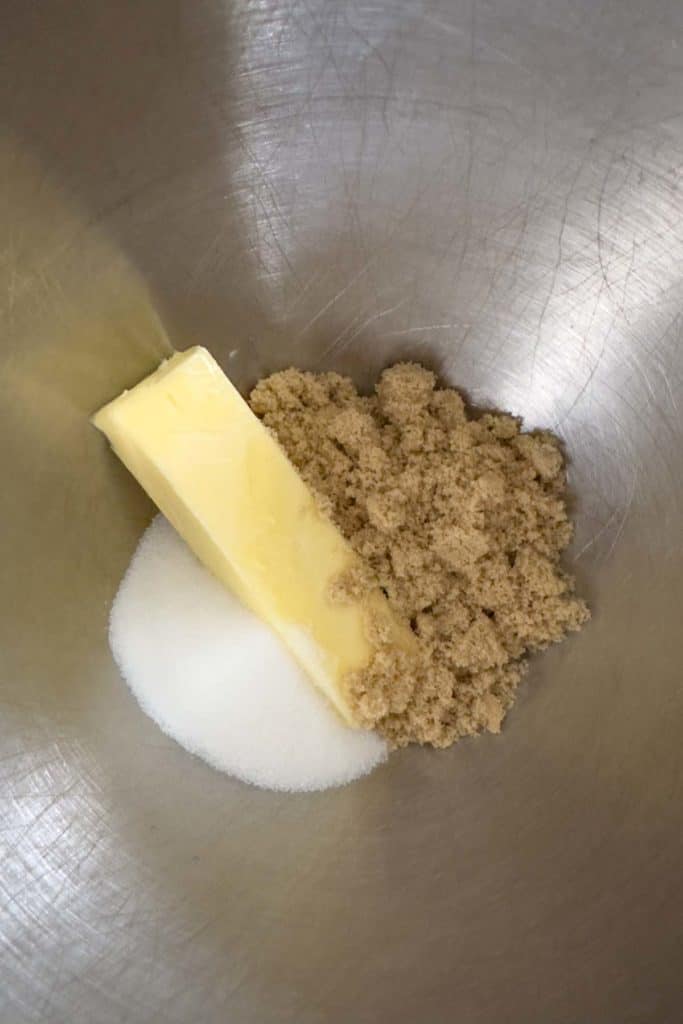 Butter and sugars in a mixing bowl before mixing.