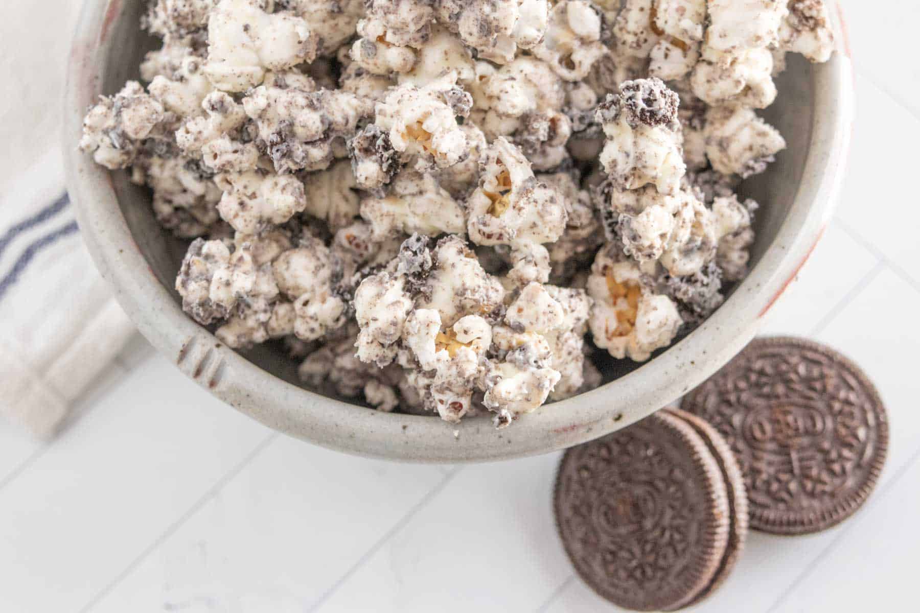 Oreo popcorn in a bowl with oreo cookies.