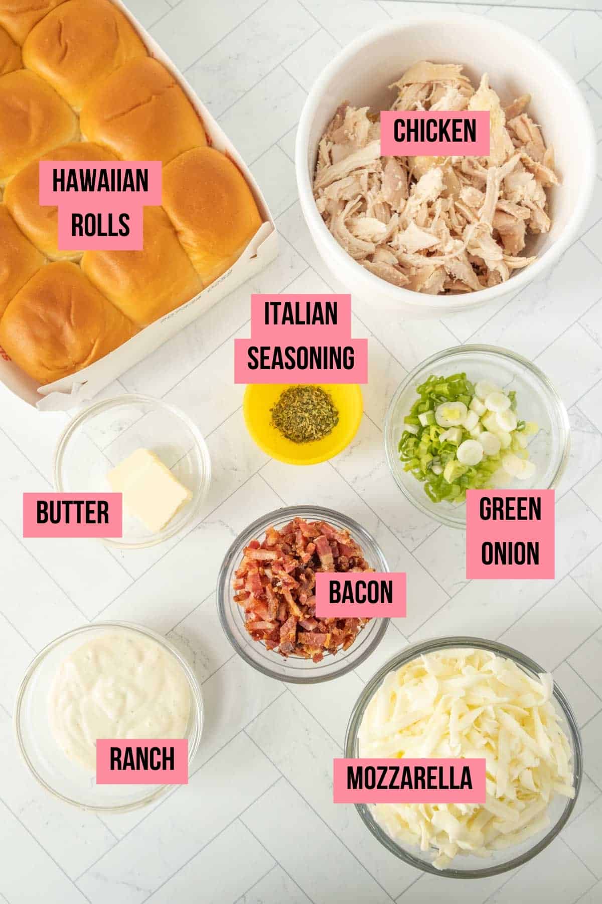 The ingredients for chicken sliders are shown on a white table.