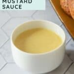 A white bowl filled with creamy honey mustard sauce sits on a gray surface next to a plate of pretzels. Text reads "Perfect for dipping honey mustard sauce.