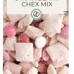 Close-up of strawberry Chex mix with powdered cereal squares and pink, red, and white candy pieces. Text overlay reads "Strawberry Chex Mix," highlighting this sweet and colorful snack.