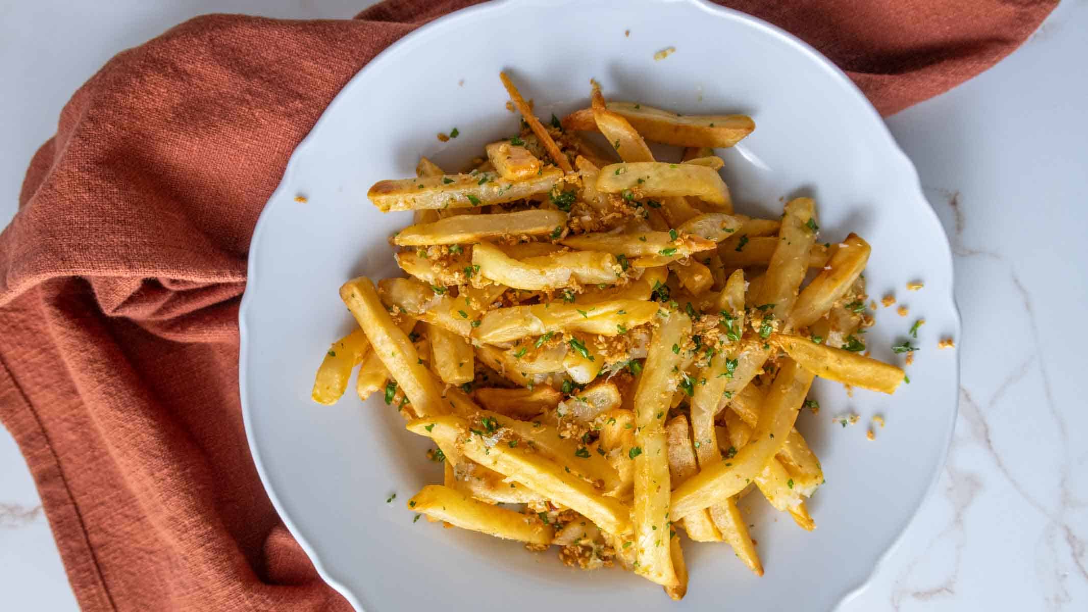 Crispy garlic fries sprinkled with herbs.