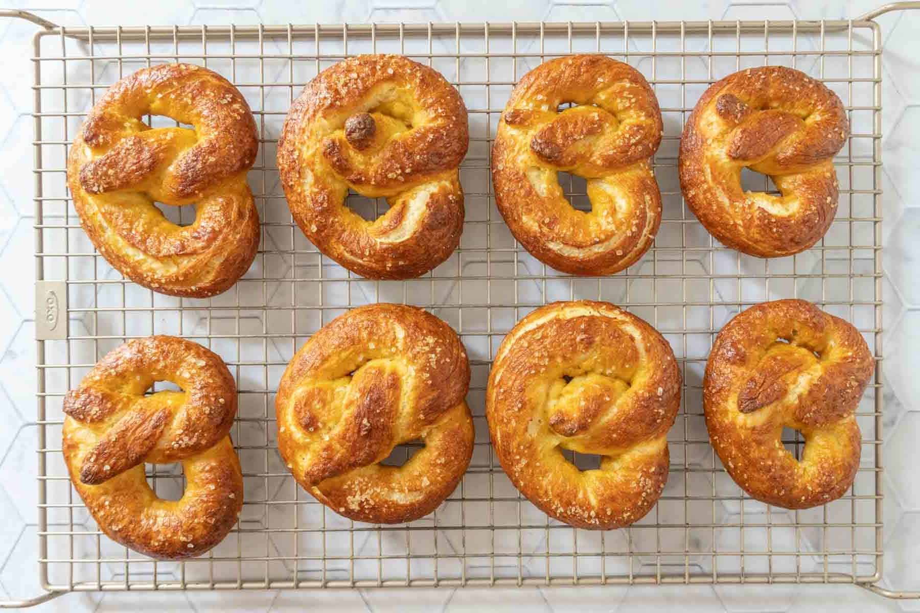 Homemade soft pretzels on a cooling rack.