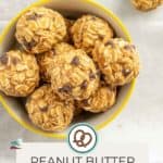 Bowl of peanut butter oat balls on a table, with a sign reading "Peanut Butter Oat Balls" and a website URL below.