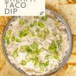 Bowl of creamy taco dip topped with green onions, surrounded by tortilla chips. Text overlay: "Easy Recipe, Creamy Taco Dip" and "HAPPYSNACKCIDENTS.COM".