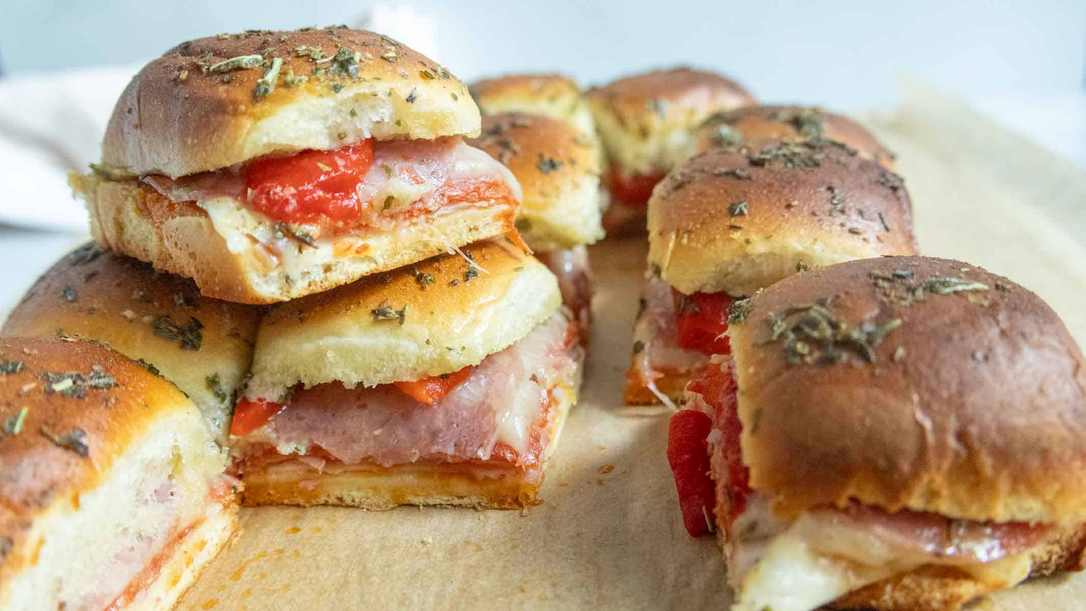 Italian sliders with meat, cheese, and toppings.
