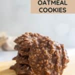 A stack of no bake chocolate oatmeal cookies is displayed on a wooden board, with text reading "No Bake Chocolate Oatmeal Cookies" in the background.